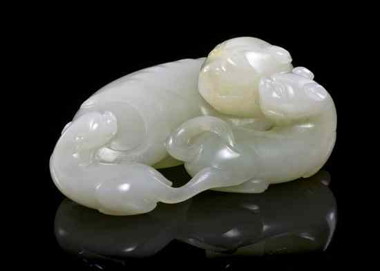 Appraisal: A Jade Carving of a Mother and Two Pups of