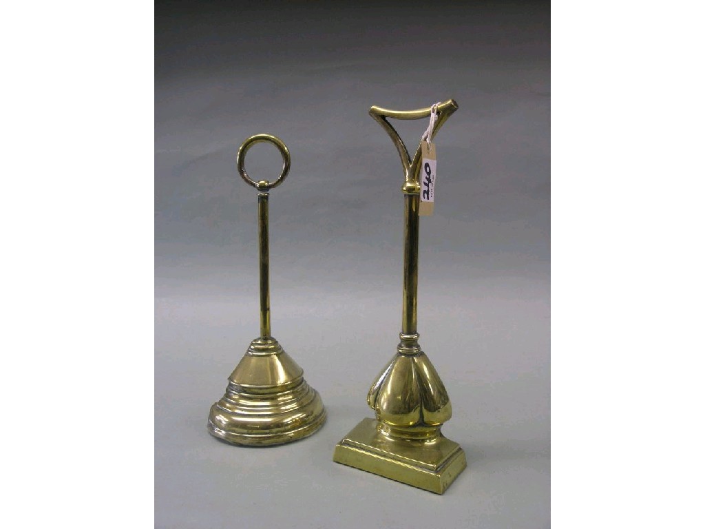 Appraisal: Two Victorian brass door stops in high and a brass