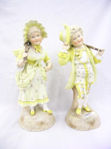 Appraisal: Pair of painted bisque statues tall depicting boy in floral