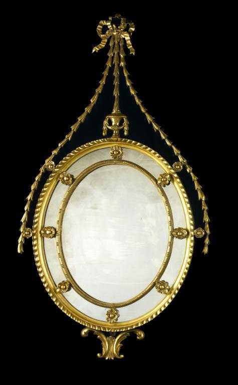 Appraisal: A GILTWOOD MIRROR the gadrooned oval frame with border of