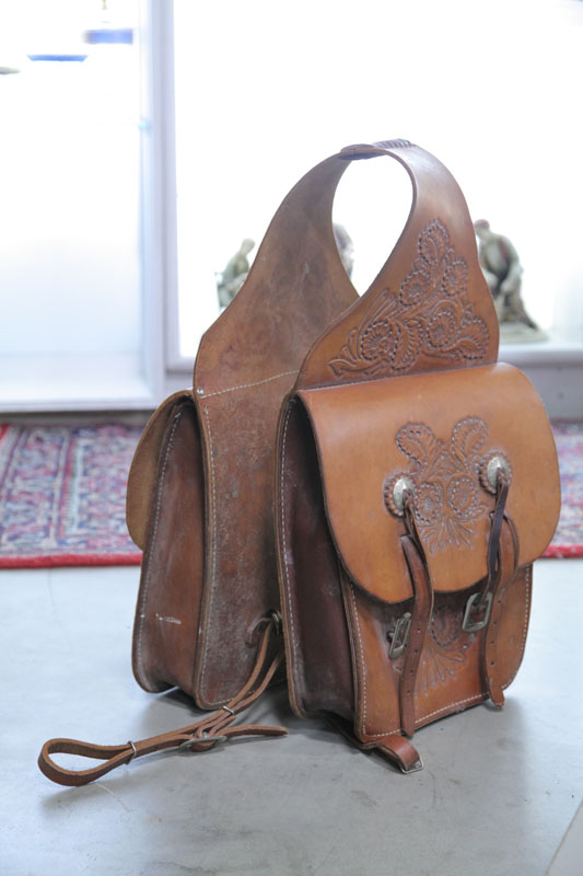 Appraisal: LEATHER SADDLE BAGS Tooled bags with foliate decoration and star