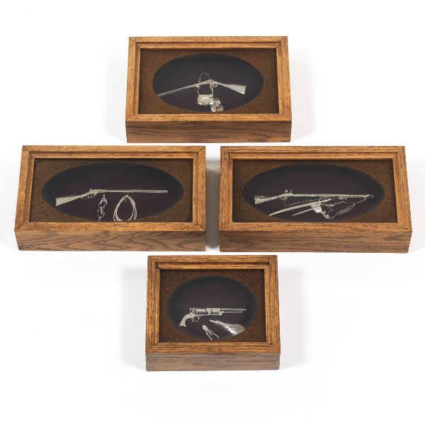 Appraisal: FRED CRISSMAN FOUR MINIATURE STERLING WESTERN SHADOWBOX GUNS Four shadowboxes