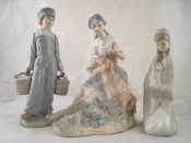 Appraisal: Ceramics Two Lladro figures one of a Dutch boy carrying