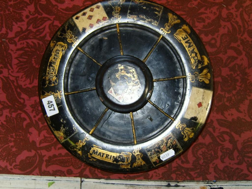 Appraisal: A th century black lacquered games wheel with playing card