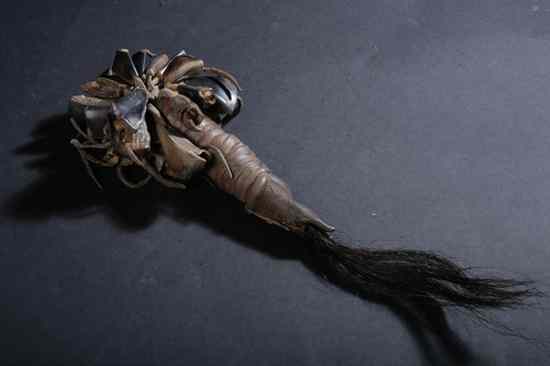 Appraisal: NAVAJO MEDICINE MAN RATTLE Comprising rawhide wrapped and horsehair handle