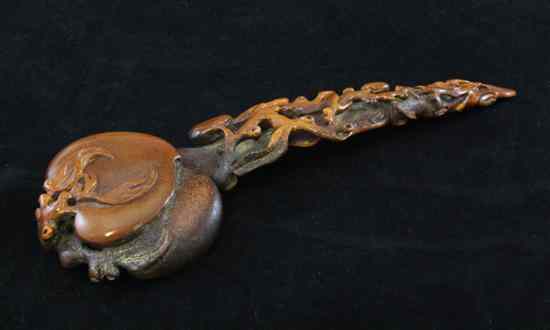 Appraisal: A Chinese horn ruyi sceptre the head carved as two