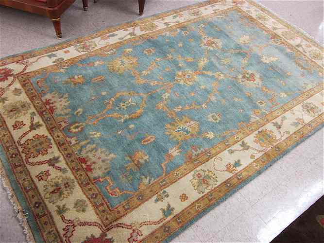 Appraisal: HAND KNOTTED ORIENTAL CARPET Indo-Persian Oushak design on light blue