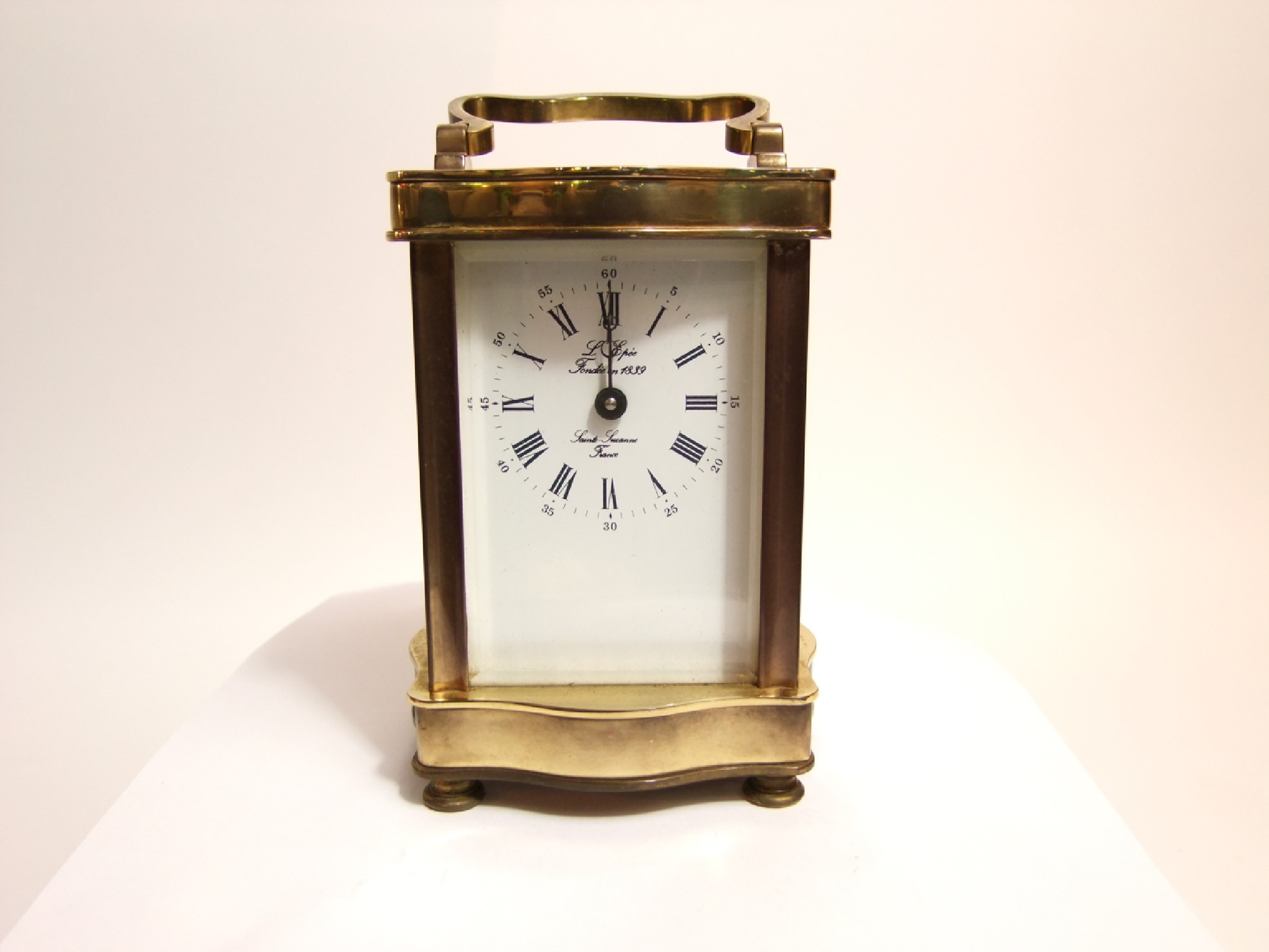 Appraisal: A brass carriage clock in gorge a shaped case with