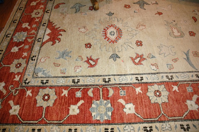 Appraisal: AN AFGHAN ZIEGLER CARPET Having a cream field and terracotta