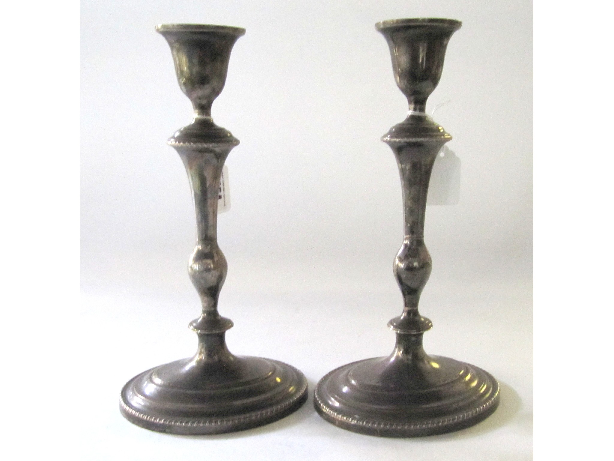 Appraisal: A pair of silver plated candlesticks