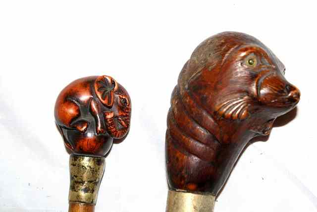 Appraisal: A ROSEWOOD WALKING CANE with the handle carved in the