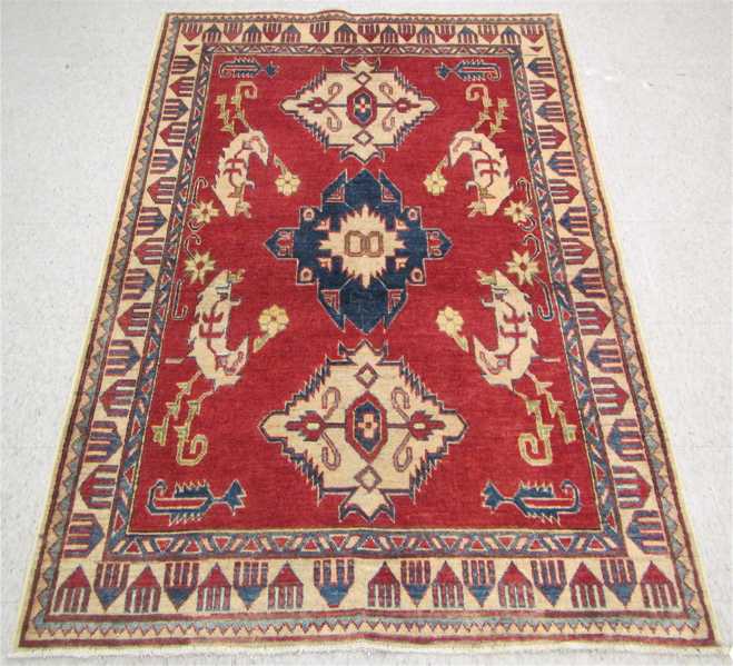 Appraisal: HAND KNOTTED ORIENTAL AREA RUG Pakistani-Caucasian triple geometric medallion design