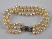 Appraisal: A three row cultured pearl bracelet with a carat white