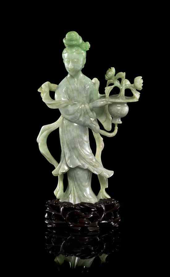 Appraisal: A Chinese Jadeite Carving of a Woman of green and