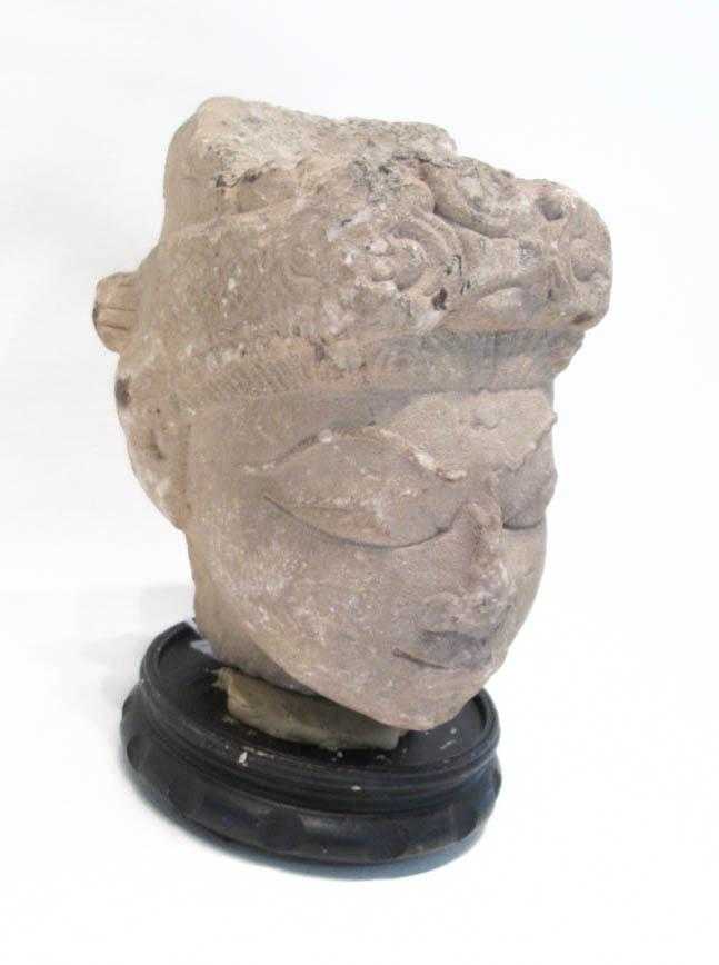 Appraisal: CARVED SANDSTONE HEAD with circular wood base Head height inches