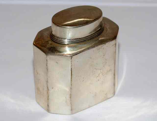 Appraisal: A SILVER OCTAGONAL SHAPED SILVER TEA CADDY with an oval