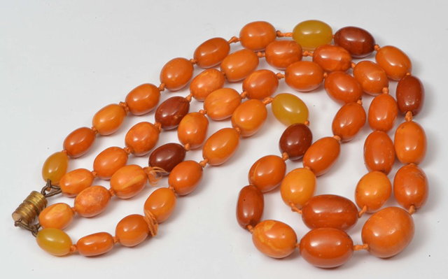 Appraisal: A TWO STRING COLOURED AMBER BEAD NECKLACE grams