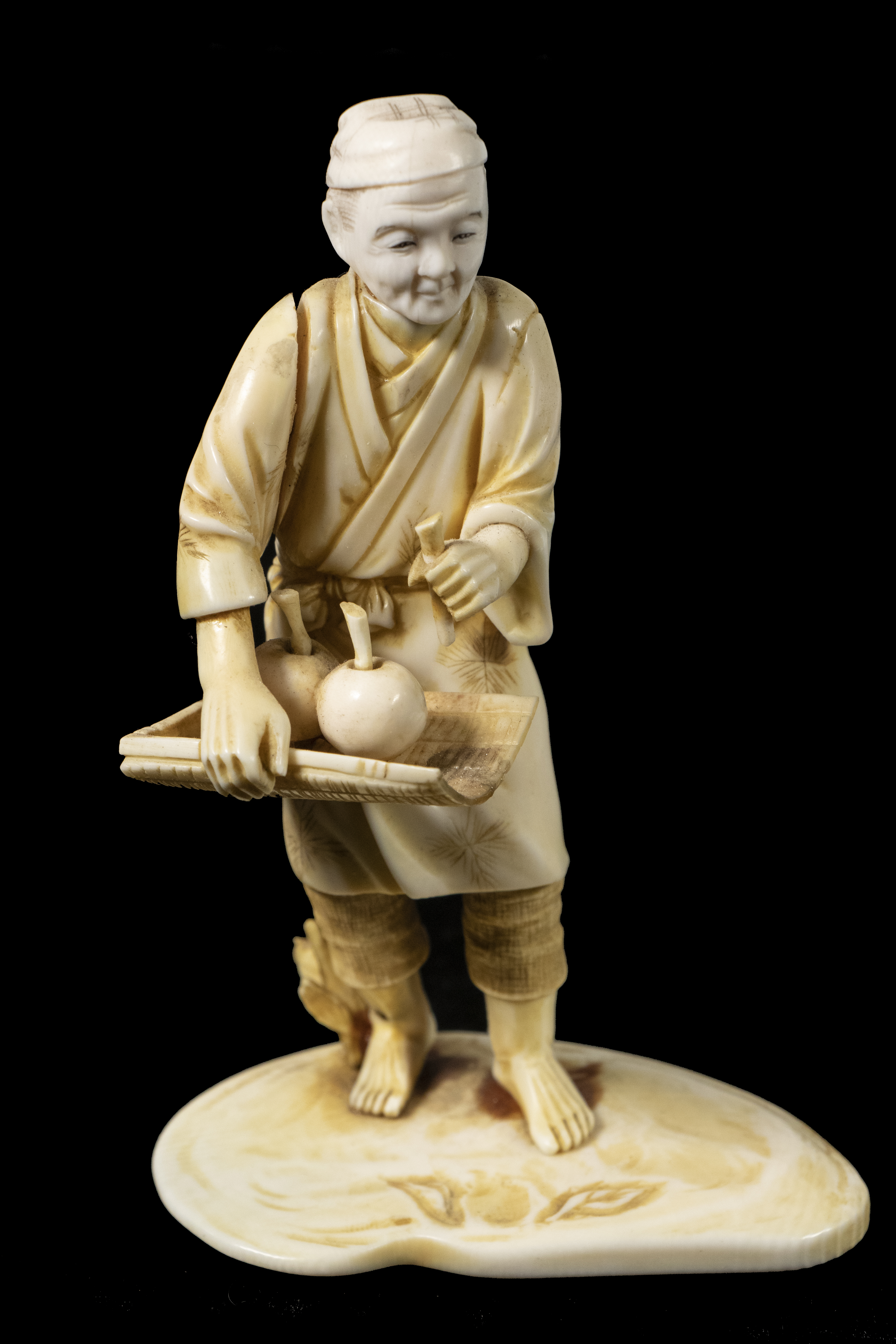 Appraisal: TH C JAPANESE IVORY OKIMONO SIGNED Capped Man Selling Fruit