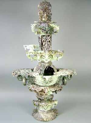 Appraisal: A th century celadon jadeite multi-tiered centrepiece elaborately carved with