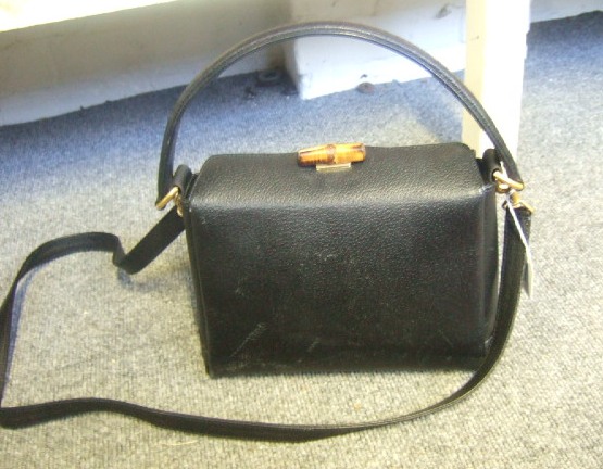 Appraisal: A Gucci black leather handbag with brass mounts and bamboo