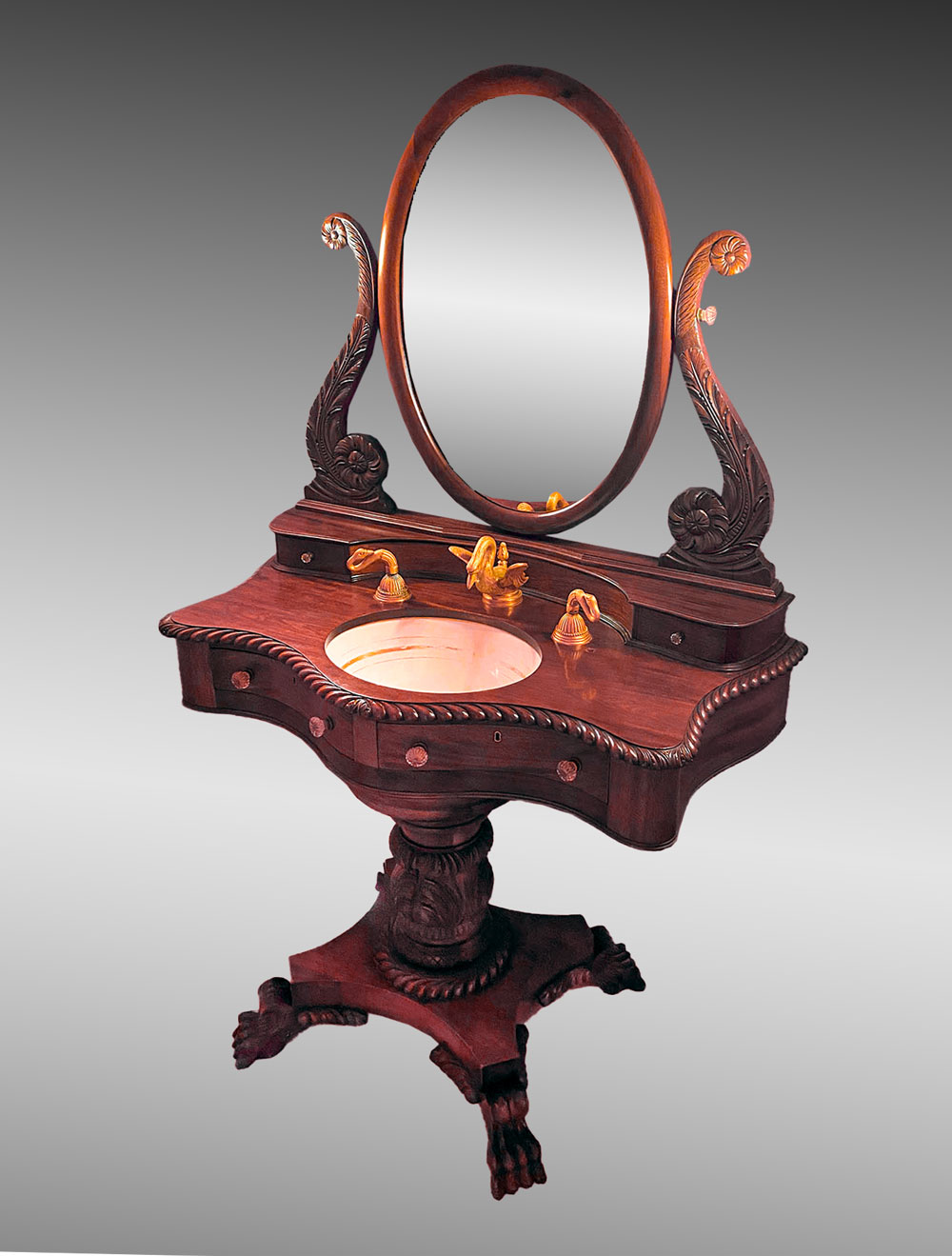 Appraisal: MAHOGANY PEDESTAL VANITY SINK Surmounting oval mirror flanked by carved