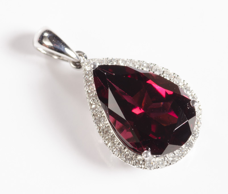 Appraisal: GARNET DIAMOND AND FOURTEEN KARAT WHITE GOLD PENDANT set with