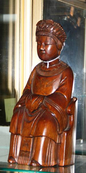 Appraisal: A lacqured carved hard wood seated Daoist Deity Late Qing