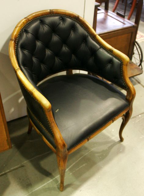 Appraisal: A set of bamoo and leather upholstered armchairs