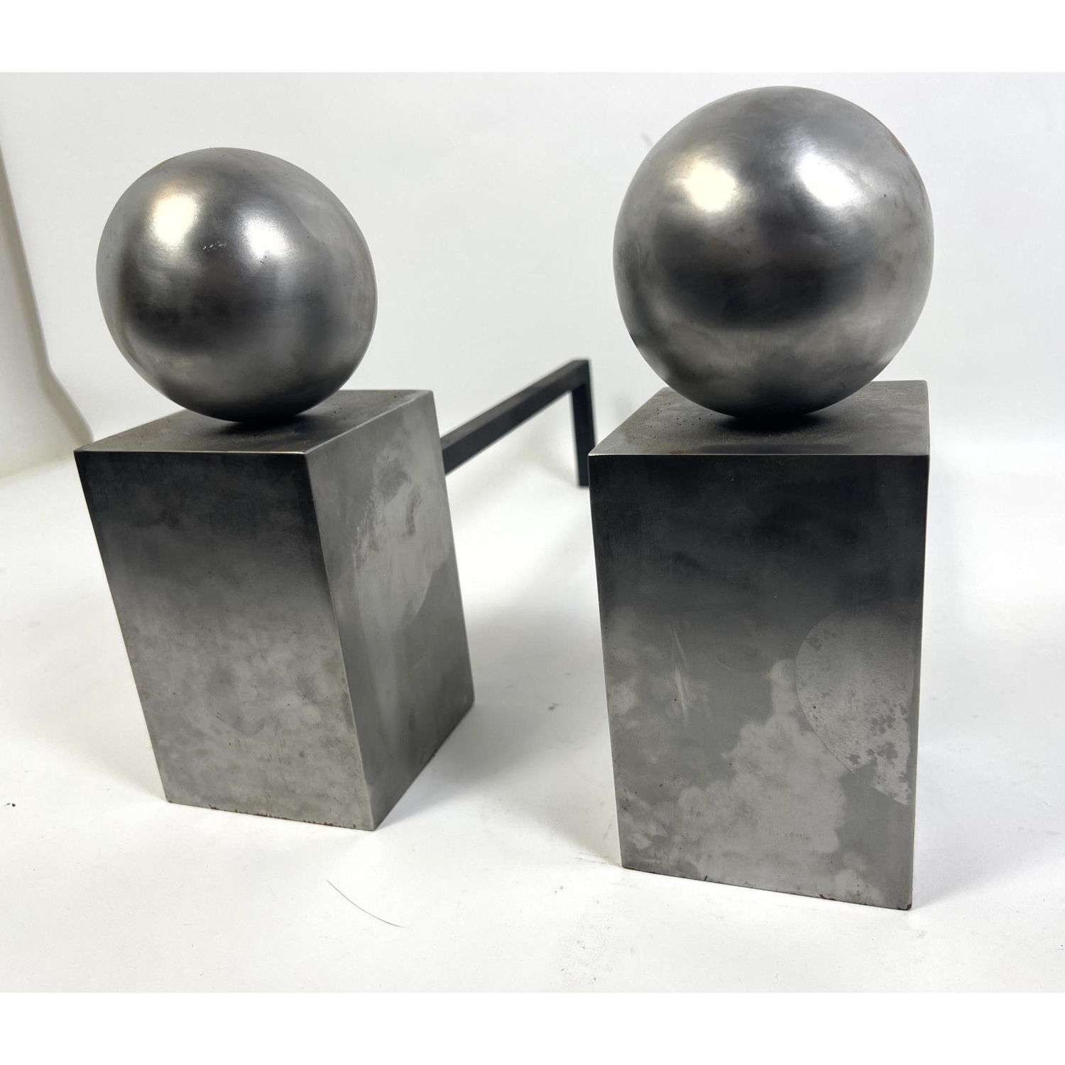 Appraisal: Modernist Metal Ball And Square Column Andirons Stylish Design Art