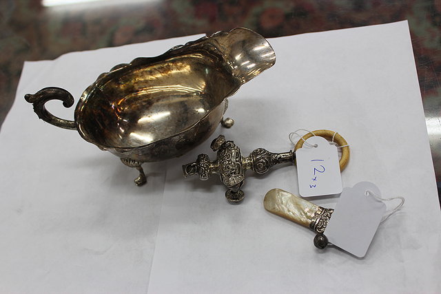 Appraisal: A SILVER SAUCE BOAT with scrolling handle shaped edge and