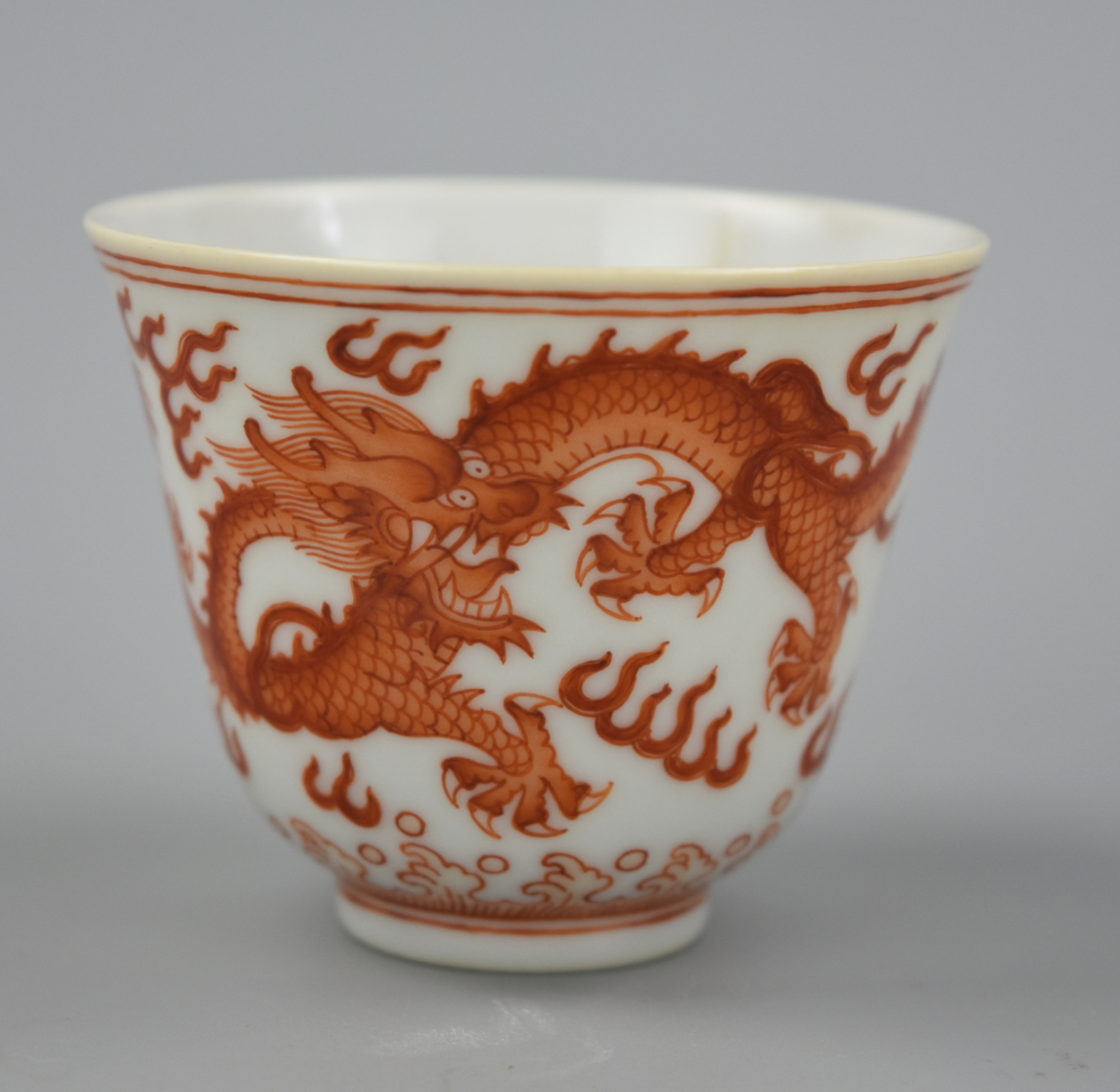 Appraisal: CHINESE IRON RED DRAGON CUP W XUANTONG MARK A Xuantong