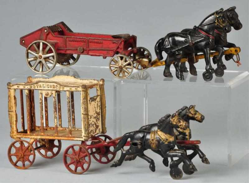 Appraisal: Lot of Cast Iron Horse-Drawn Vehicle Toys Description Includes one