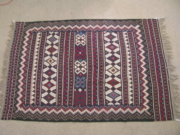 Appraisal: Kilim hand knotted wool carpet with brown black blue and