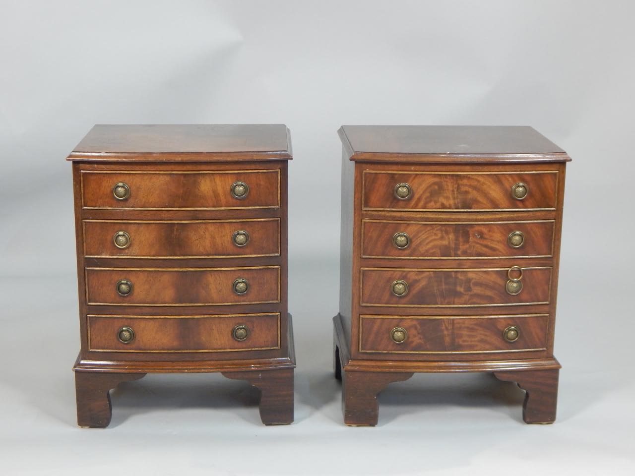 Appraisal: A pair of reproduction mahogany bedside chests each with four