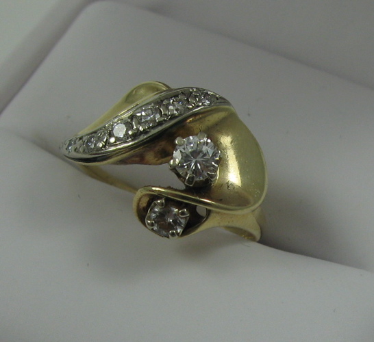 Appraisal: DIAMOND AND FOURTEEN KARAT GOLD RING set with eight round-cut