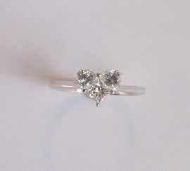 Appraisal: A platinum diamond ring set with two half moon shaped