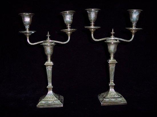 Appraisal: A pair of candlesticks of Adam design with fluted nozzles