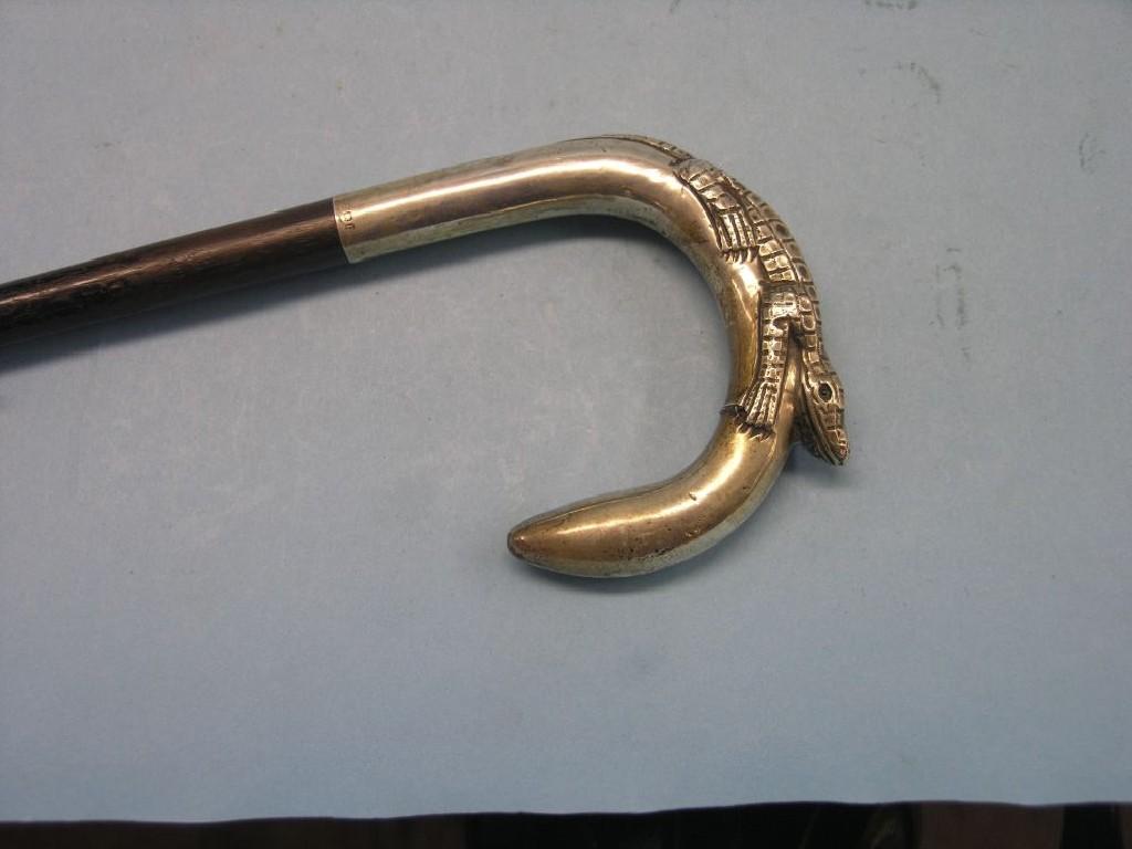 Appraisal: A silver-mounted walking stick handle in form of a small