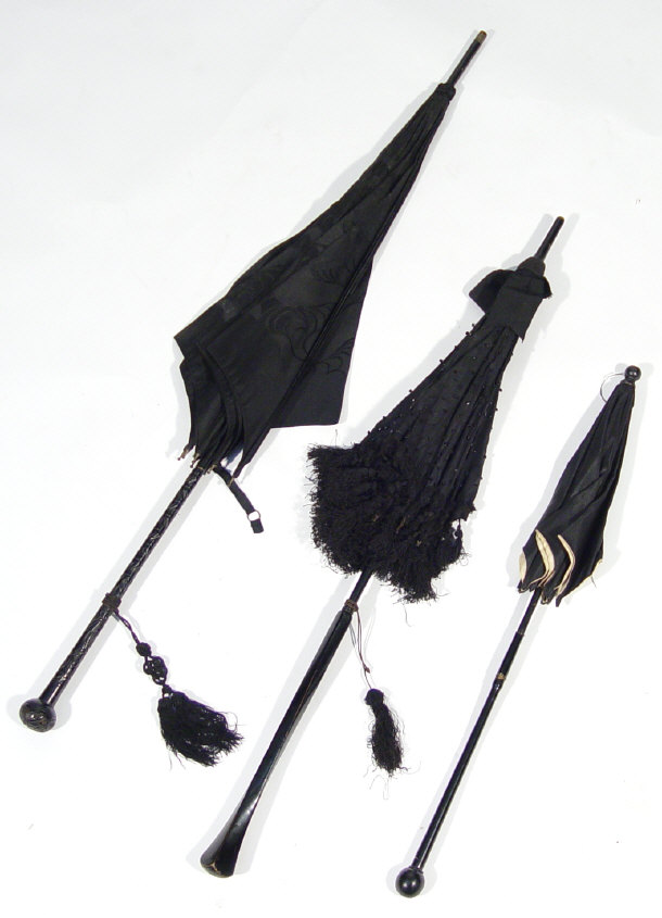 Appraisal: Three Victorian ebonised mourning parasols one with a carved handle