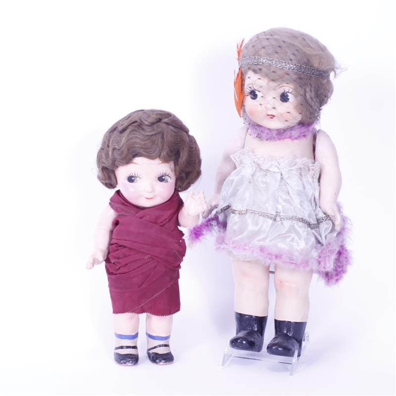 Appraisal: Two Composition Kewpie style Character Dolls dressed in 's Flapper