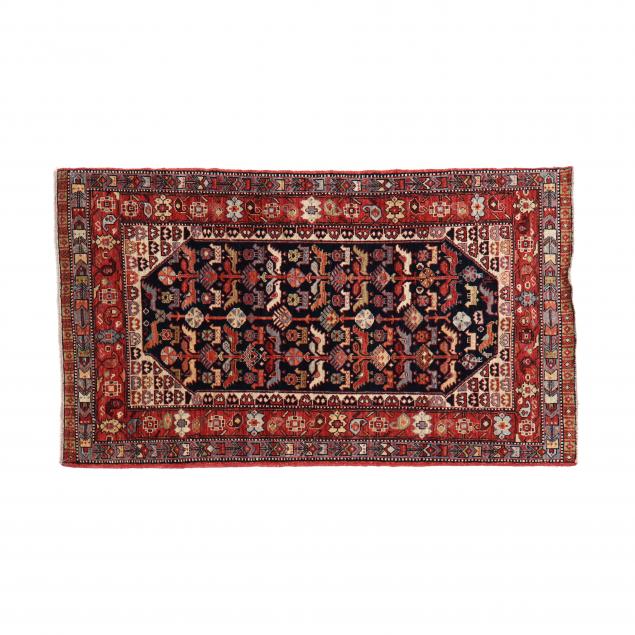 Appraisal: KHAMSEH AREA RUG Beige field with center blue medallion with