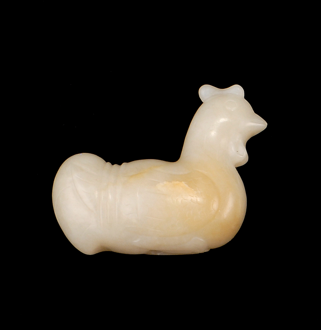 Appraisal: WHITE AND RUSSET JADE BEAD In rooster form Length cm