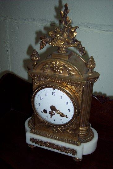 Appraisal: A French ormolu mantel clock circa with enamel dial and