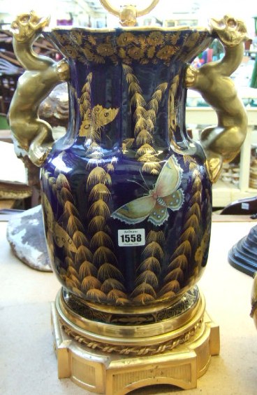 Appraisal: A blue glazed pottery lamp base gilt decorated with flowers