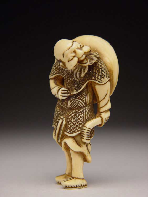 Appraisal: ANTIQUE IVORY NETSUKE Antique carved ivory netsuke of a standing