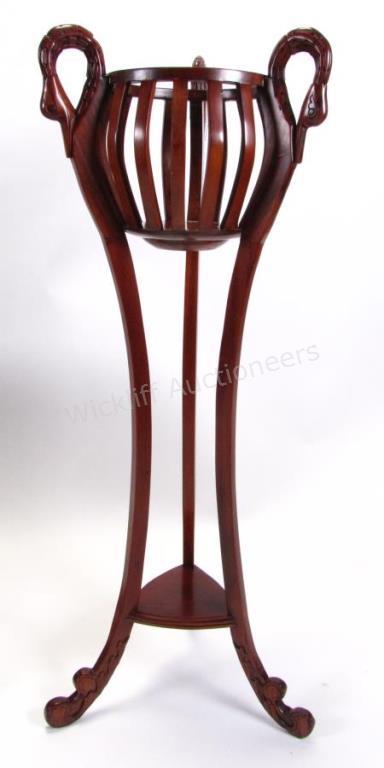 Appraisal: A mahogany ferner with goose neck motif carvings open basket