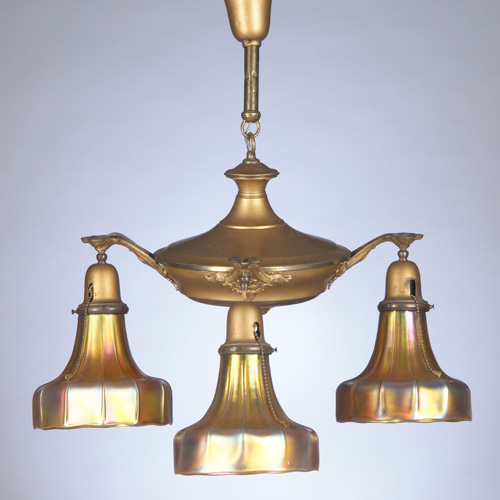 Appraisal: STEUBEN Four-fixture brass chandelier with Steuben gold Aurene fluted shades