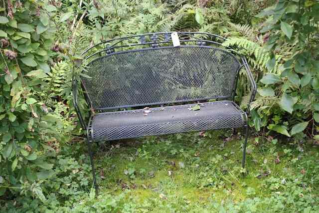 Appraisal: A PAIR OF BLACK PAINTED WROUGHT IRON GARDEN SEATS wide