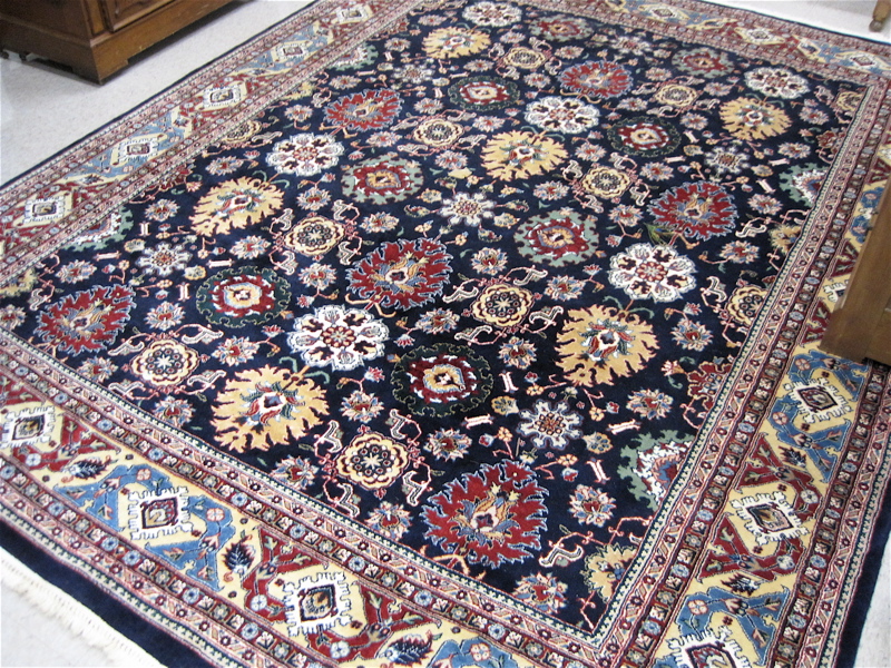 Appraisal: HAND KNOTTED ORIENTAL CARPET Pakistani-Persian the dark blue field decorated