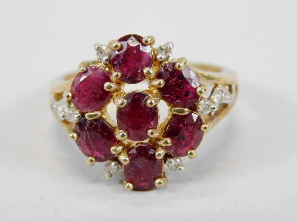 Appraisal: A ct gold dress ring set with garnets and white